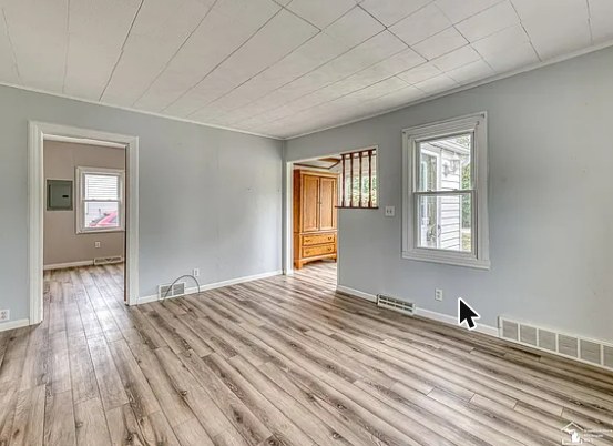 Bedroom with hardwood-look flooring and closet