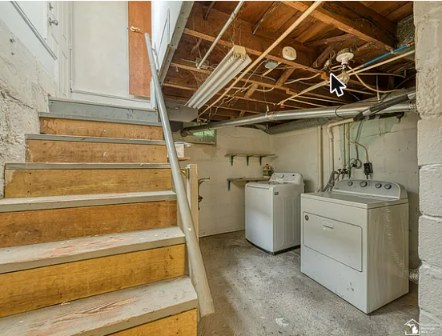 Basement laundry area with washer and dryer included