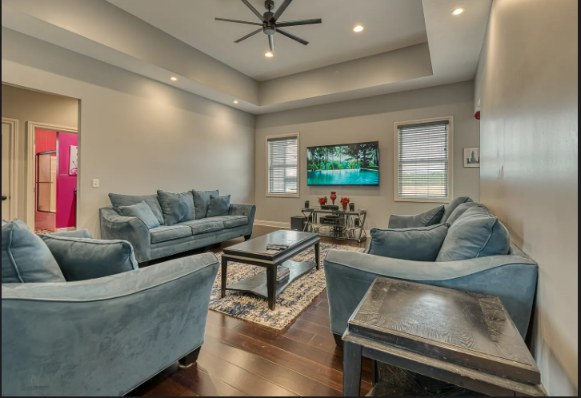 Living room with vaulted ceiling and blue sectional seating