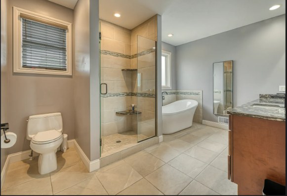 Primary bathroom with glass shower and freestanding soaking tub